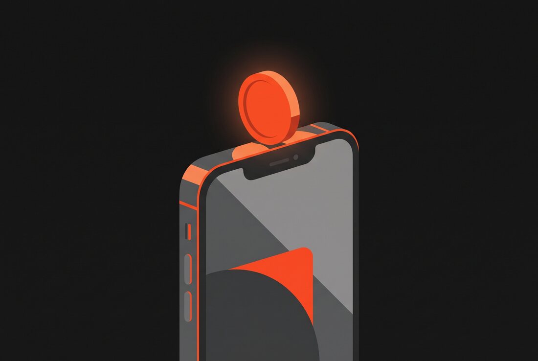 A coin balanced on the edge of a phone against a dark charcoal background with a warm ember glow.